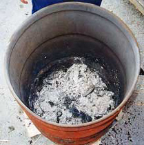 Here is the interior of the sawdust barrel after the firing. Doesn't look like much huh? Well you just wait. Underneath all that burnt white ash are some screaming colors and jet blacks.. I unload after all smoke has cleared and pots have cooled.